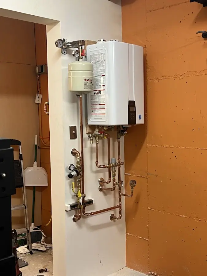 Plumbing technician inspecting water heater connections in North Bay Village